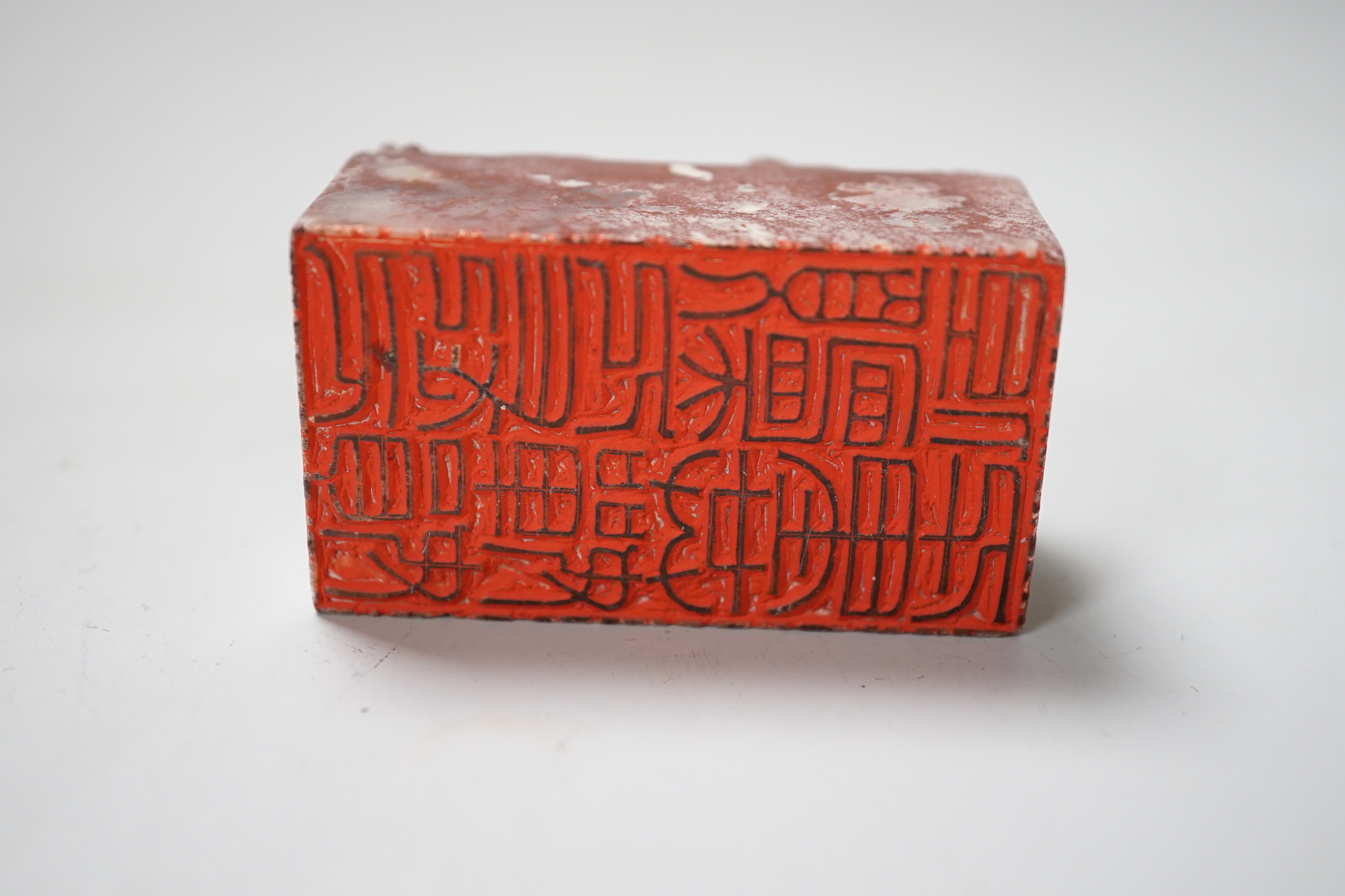 A Chinese chicken’s blood inscribed soapstone seal, carved with a dragon, 6cm